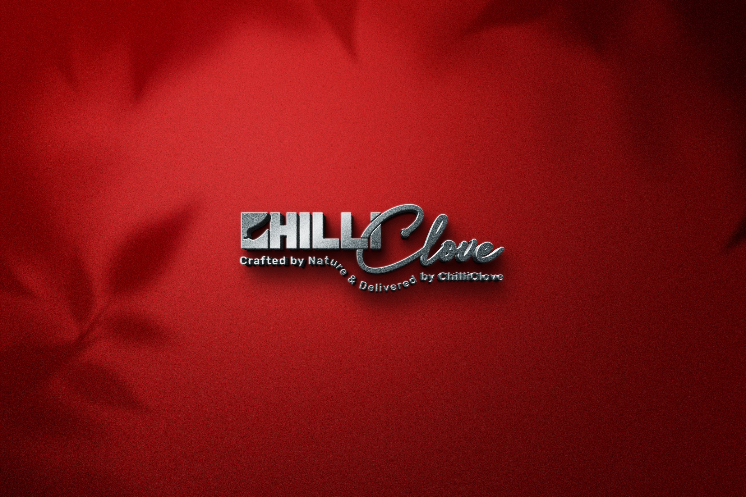 ChilliClove logo embossed on red fabric with leaf shadows