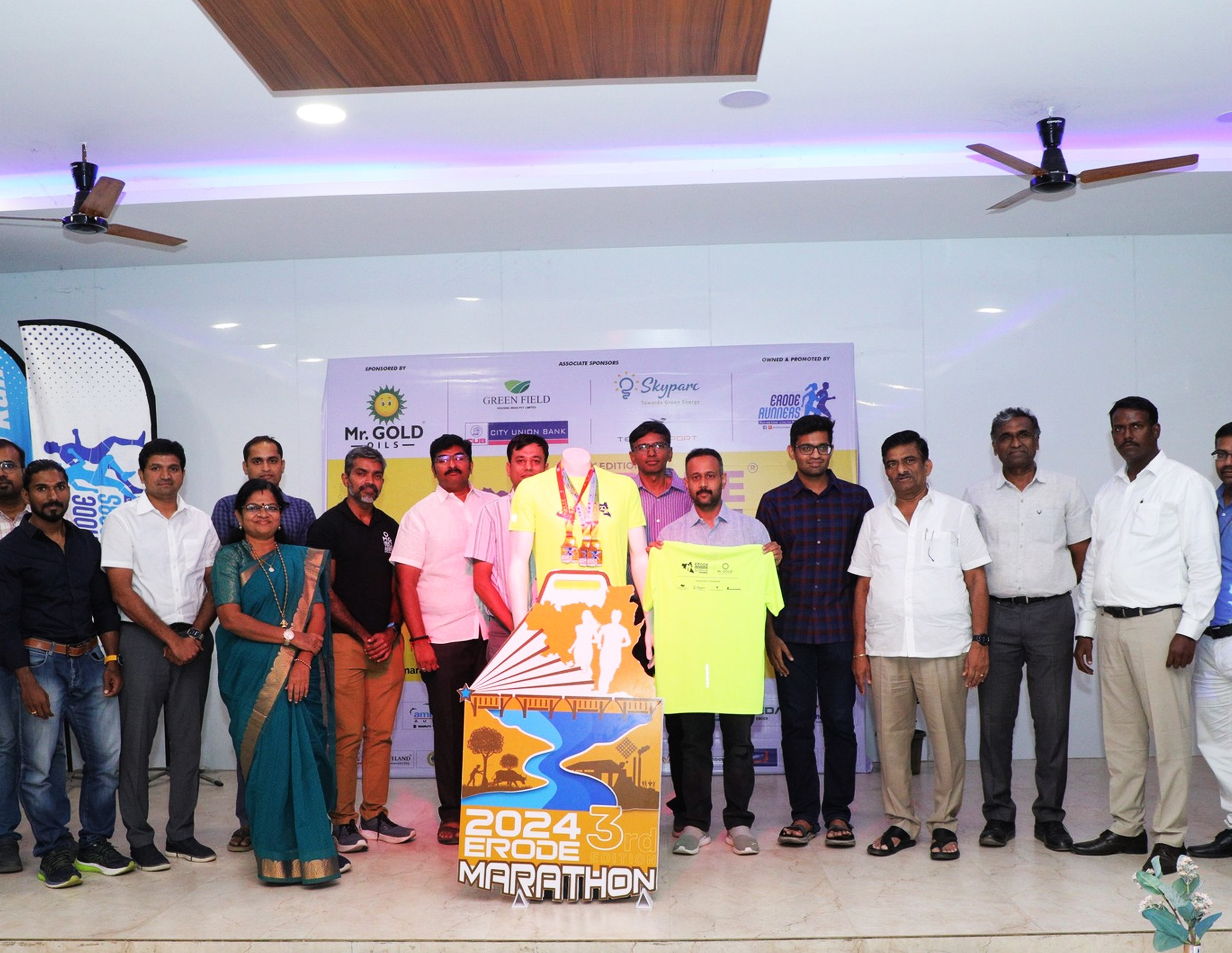 Erode Marathon 2024 event stage with organisers holding the finisher medal