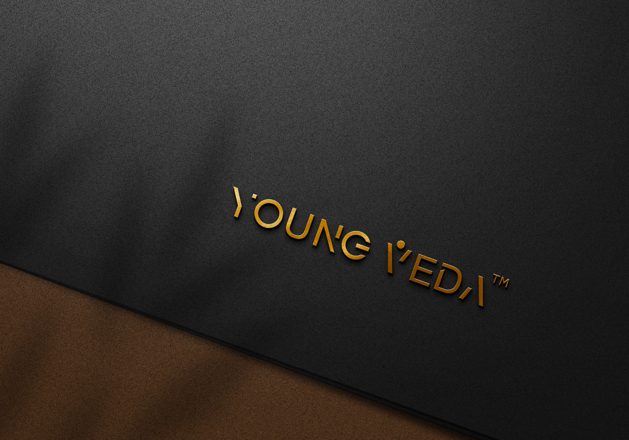 Young Veda logo embossed in gold on dark material